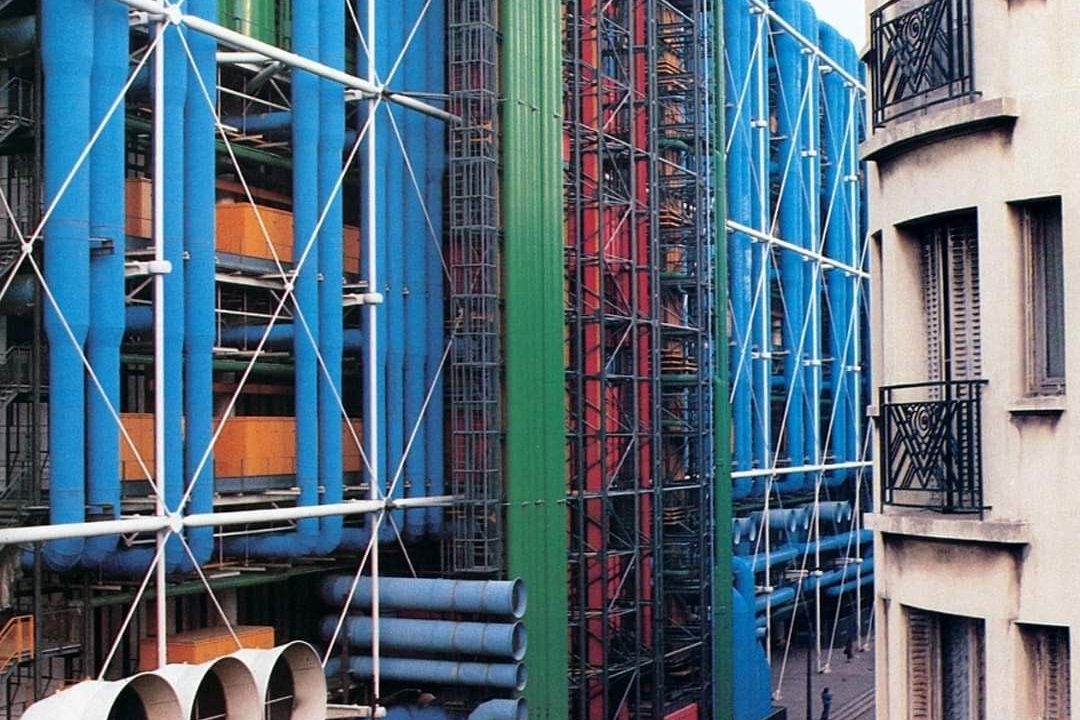 The exposed, colour-coded service pipes and structural bracing on the exterior of the Centre Pompidou in Paris.